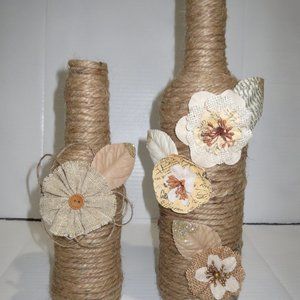 2 jute wrapped wine bottles/vases. Burlap flowers.